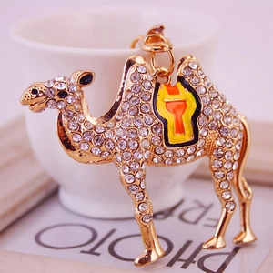 Sparkling gold camel keychain with white rhinestones and orange enamel accents