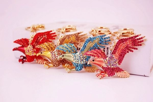 Detail showing four eagle-shaped keychains with colorful rhinestones and lobster clasps