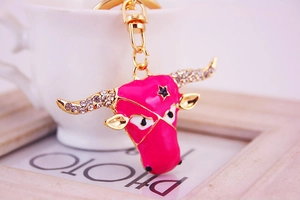Detail of pink bull head keychain with sparkling rhinestones and gold metal finish