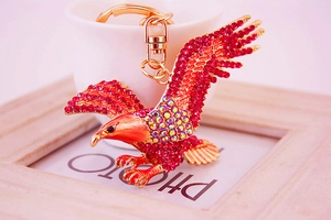 Close-up of eagle keychain with pink rhinestones and gold lobster clasp