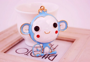 Detail of a cartoon monkey keychain with blue enamel and sparkling rhinestone eyes