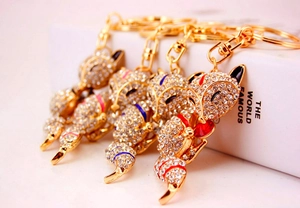 Detailed view of four fox keychains with gold plating and sparkling crystal rhinestones