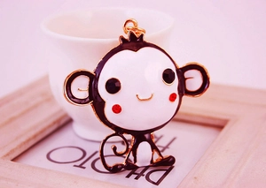 Detail of cute monkey keychain with enamel drip oil finish and sparkling rhinestones