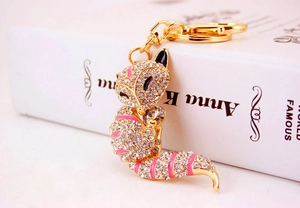 Detail of fox-shaped keychain with gold alloy plating, pink enamel and sparkling crystals