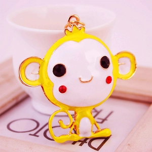 Cute cartoon monkey keychain with yellow enamel finish and sparkling rhinestone eyes