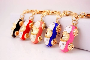 Detail showing five colorful alloy car keychains with crystals and drip oil finish