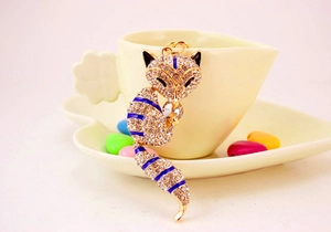 Detail of crystal fox keychain with gold plating and blue enamel accents for bags