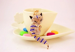 Detailed macro view of crystal fox keychain with blue enamel and gold finish