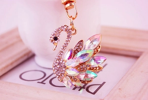 Detailed macro view of gold swan keychain featuring white rhinestones and AB crystals