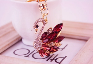 Detail of crystal swan keychain with red stones and golden lobster clasp