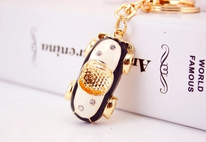 Macro shot of creative car keychain with blue enamel finish and sparkling crystal accents