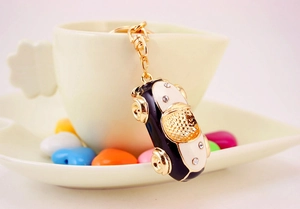 Detailed close-up of a vintage car keychain with gold metal and crystal accents