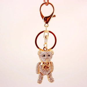 Cute teddy bear keychain pendant with gold plating and sparkling white rhinestones