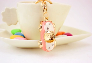 Close-up of pink enamel car keychain with sparkling rhinestones in a cozy setting