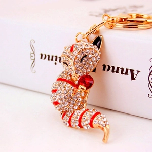 Golden alloy fox keychain with sparkling crystals and large red heart gemstone pendant
