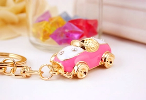 Detail of pink convertible car keychain with crystal rhinestones and golden hardware