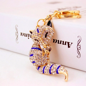 Sparkling crystal fox keychain with blue enamel details and golden lobster clasp for bags