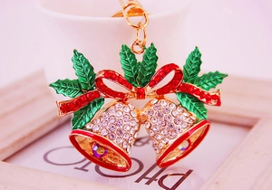 Macro view of Christmas double bell keychain with red bow and sparkling rhinestones