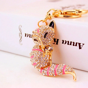 Cute golden fox keychain charm with sparkling rhinestones and pink enamel accents
