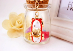 Detail of red racing car keychain with sparkling rhinestones and golden hardware