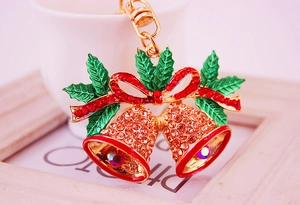 Macro detail of Christmas bell keychain with gold plating and sparkling zircon stones