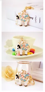Detail of creative elephant keychain featuring white enamel and colorful opal stones