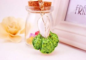 Detail of creative cabbage keychain with green rhinestones and gold metal clasp