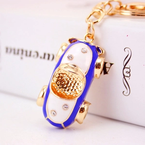 Creative blue car keychain with gold metal base and sparkling crystal accents