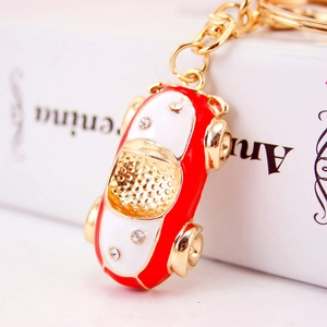 Cute red and white cartoon car keychain with rhinestones and gold metal finish