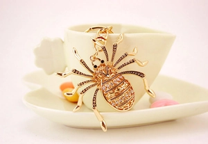 Close-up of golden spider keychain with sparkling rhinestones and lobster clasp