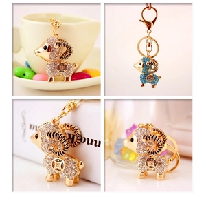 Close-up of golden sheep keychain with sparkling crystals and hollowed coin pattern