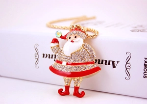 Detailed close-up of crystal-studded Santa Claus pendant with red enamel on gold chain