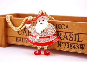 Detail showing Santa Claus pendant with white rhinestones and red enamel on a gold chain