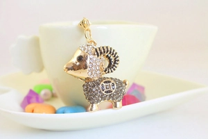 Detailed view of a gold-plated sheep keychain featuring sparkling rhinestones and hollow patterns