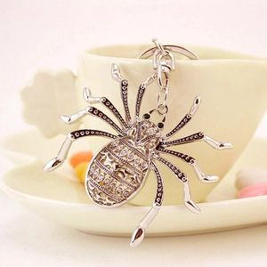 Spider keychain with white rhinestones and hollow metal carving on silver finish