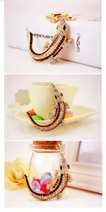 Detailed view of crocodile keychain with light and dark brown rhinestones in lifestyle settings