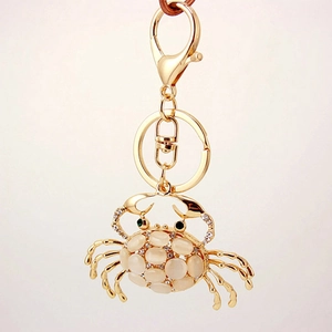 Golden opal crab metal keychain with inlaid crystals and rotating lobster clasp