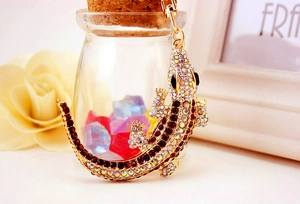 Macro detail of luxury crystal-studded crocodile keychain with glittering rhinestones