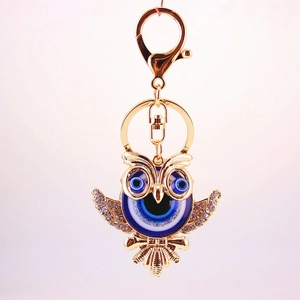 Creative owl keychain pendant with blue evil eye design and sparkling rhinestones