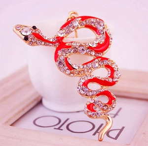 Artistic gold snake keychain with red enamel and sparkling rhinestones for bags