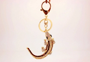 Detailed view of the sparkling crystal lizard keychain with gold plating and rhinestones