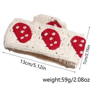 Detail view of cream crochet headband with red strawberry motif and 13cm size dimensions