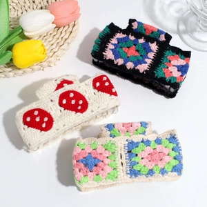 Handmade crochet hair clips with floral and strawberry patterns in set of three