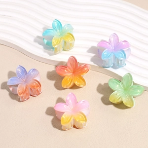 6-piece set of gradient acrylic plumeria hair claws in various vibrant summer colors