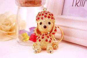 Macro shot of poodle keychain with golden alloy finish and red sparkling rhinestones