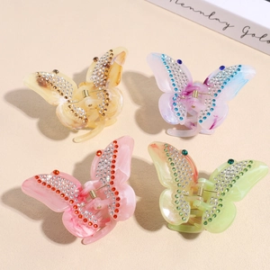 Sparkly butterfly hair claws set in amber, purple, pink, and green marble acrylic
