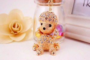 Exquisite golden poodle keychain featuring sparkling white crystal rhinestones and lobster clasp