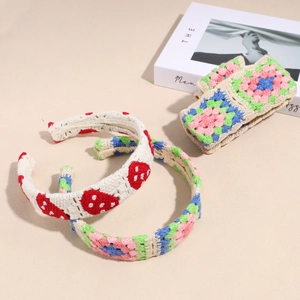 Detail showing handmade crochet floral headbands with strawberry and flower knit patterns