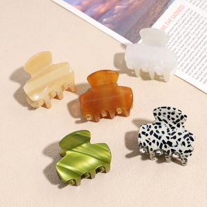 Five vintage acetate hair claws in assorted colors and patterns for elegant styling