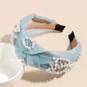 Close-up of light blue mesh headband featuring intricate pearl clusters and sparkling rhinestones